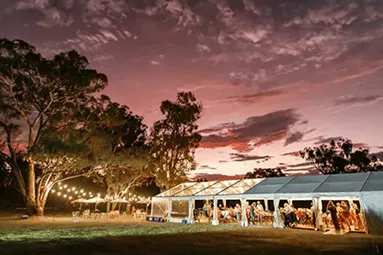 Festive outdoor party in Armidale featuring elegant marquee hire and string lighting.